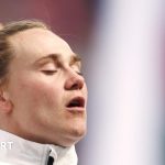 Meg Jones rugby captain leading her team on the field during a match.