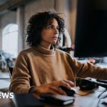 Employees working in an office, focusing on employee activity data collection.