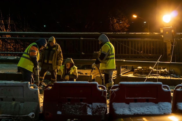 Rescued miner in flooded tunnel being helped by rescue workers.