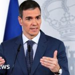 Diplomats discussing NATO member expulsion in formal attire.