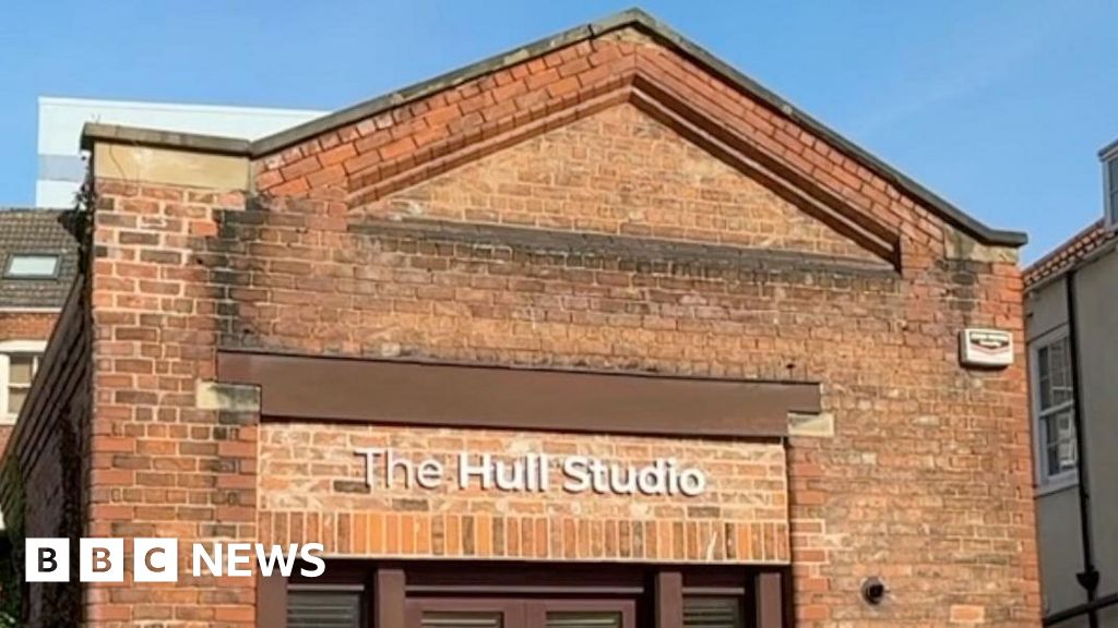 A busy creative hub in Hull with artists using green screens and cameras.