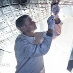 Scientists collaborating on a stellarator for clean energy research.