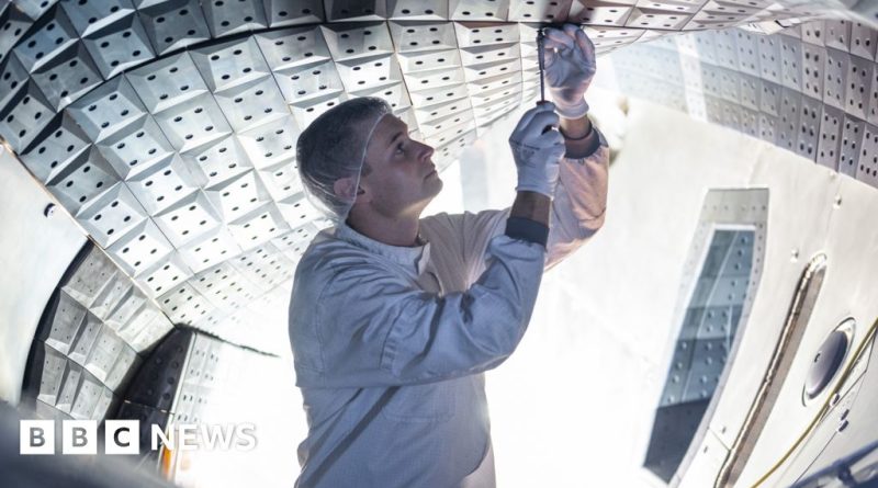 Scientists collaborating on a stellarator for clean energy research.
