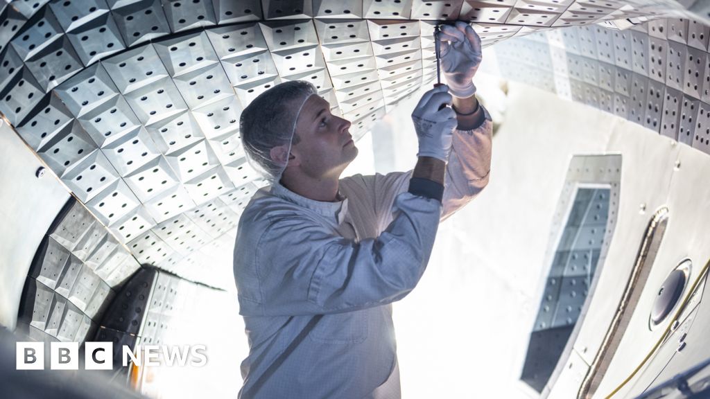 Scientists collaborating on a stellarator for clean energy research.