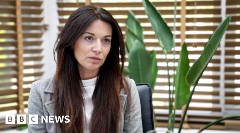 Women discussing women's healthcare initiative in a modern office setting.