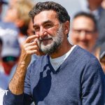 Business professionals discussing strategies for Newcastle United's future.