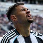 Newcastle United struggles shown through a team huddle with focus.