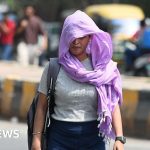 People in northern India navigate a heatwave with heatwave warnings.