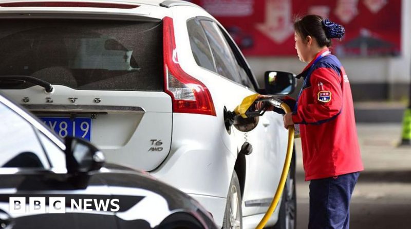 Professionals discussing oil prices rise in a modern office setting.