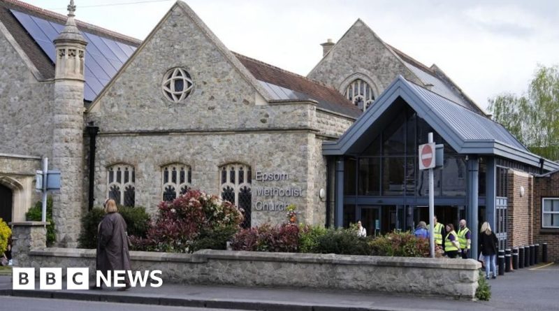 A community meeting discussing the Epsom rape incident with diverse professionals.