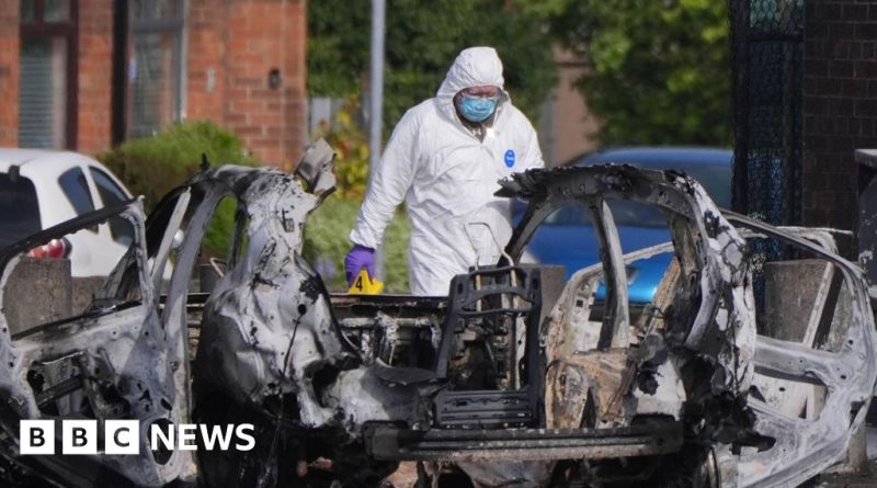 Police officers conducting increased patrols at a vehicle checkpoint for community safety.