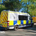 Police officers conducting a modern slavery investigation in Crewe.