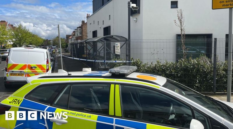 Police officers investigating near a synagogue after an attempted arson incident.