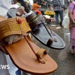 Models presenting Prada Indian sandals in a professional fashion setting.