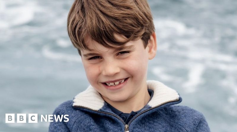 A joyful young boy in a birthday portrait, celebrating his birthday outdoors.