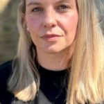 A woman expressing relief in a doctor's office after discussing her private hysterectomy.