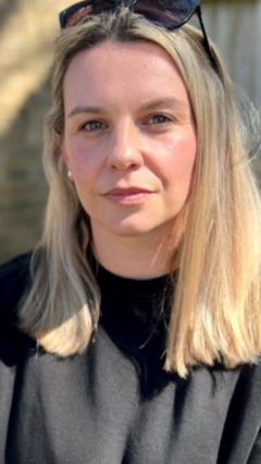 A woman expressing relief in a doctor's office after discussing her private hysterectomy.