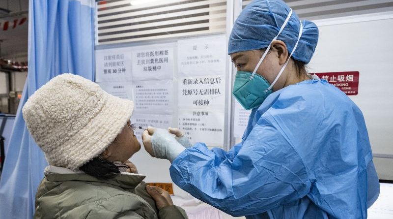 Researchers in a lab discuss the nasal vaccine Covid-19 development.