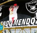 Diverse football players strategizing together, highlighting Mendoza NFL Draft pick.