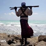 Professionals discussing maritime security strategies related to pirate attack oil tanker.