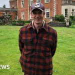 A vibrant community festival scene showing people enjoying food and entertainment at the Red Rooster Festival.