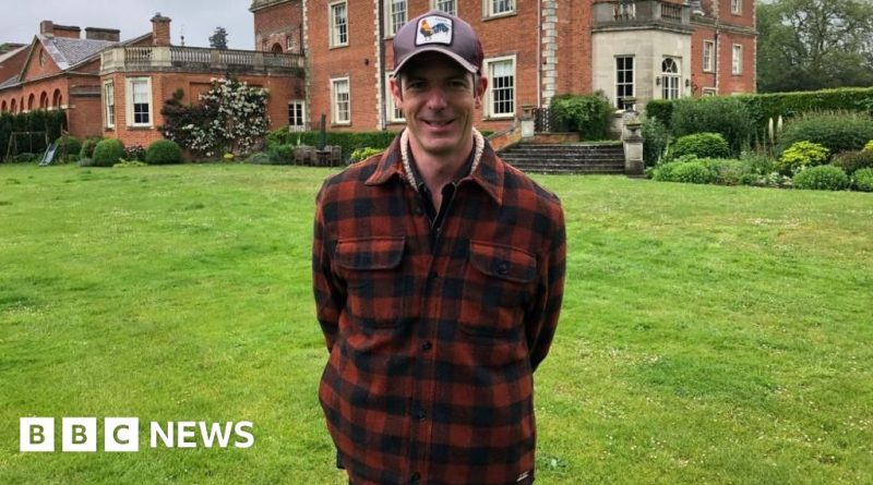 A vibrant community festival scene showing people enjoying food and entertainment at the Red Rooster Festival.
