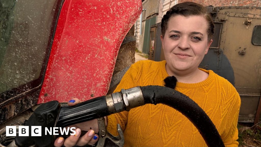 Farmers discussing the impact of rising red diesel prices in a field.