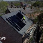 Solar energy solutions with technicians installing solar panels on rooftops.