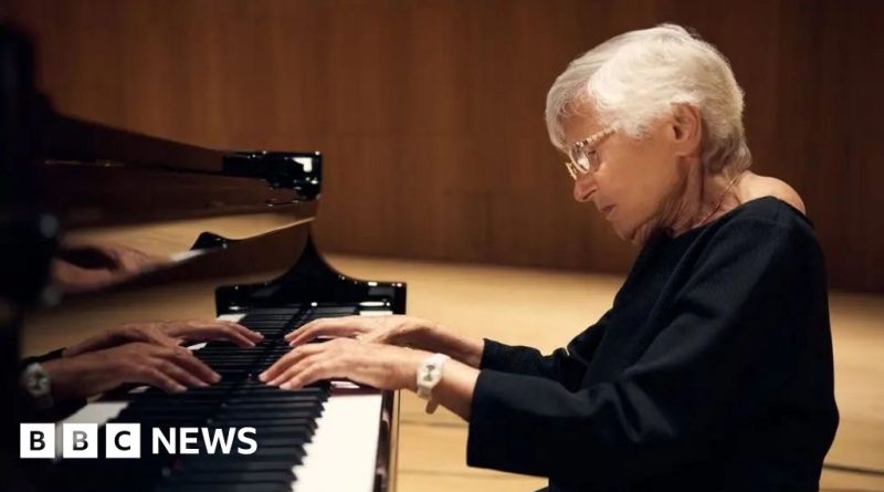 Ruth Slenczynska pianist performing passionately in a concert hall.