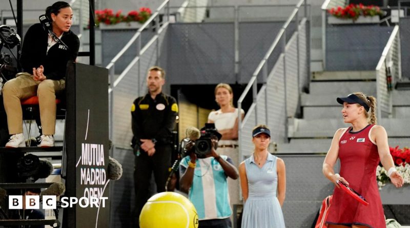 Tennis player questioning the accuracy of electronic line-calling during a match.