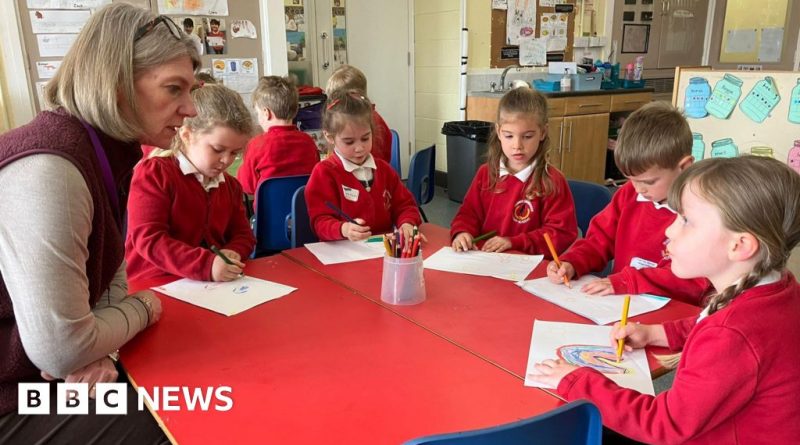 Teachers assist children in a classroom, focusing on potty training skills.