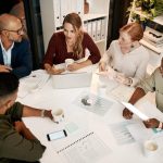 Scottish Conservatives tax cuts discussion among professionals in a modern office.