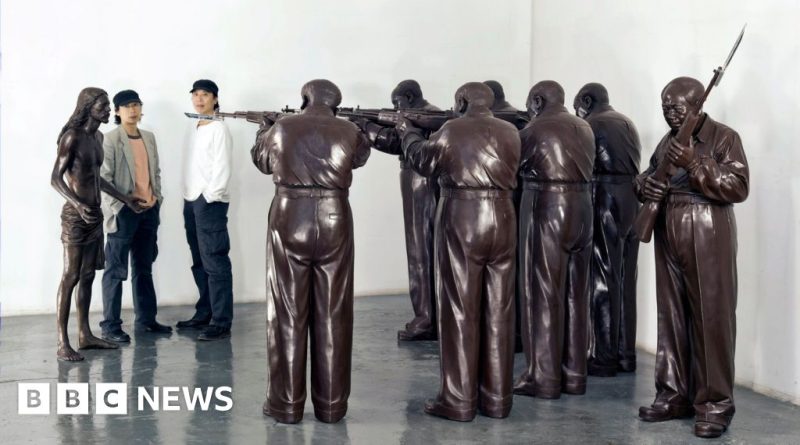 Artists discussing Gao Zhen censorship in a sculptor's studio.