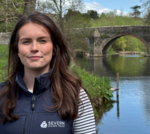 People discussing River Teme conservation efforts in nature.