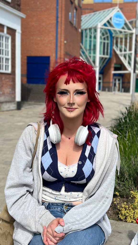 Shoppers at a renovated high street, discussing the future of local businesses.
