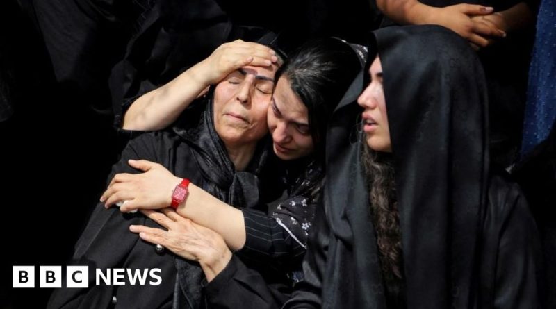 Professionals discussing the Iran school strike investigation in a serious meeting.