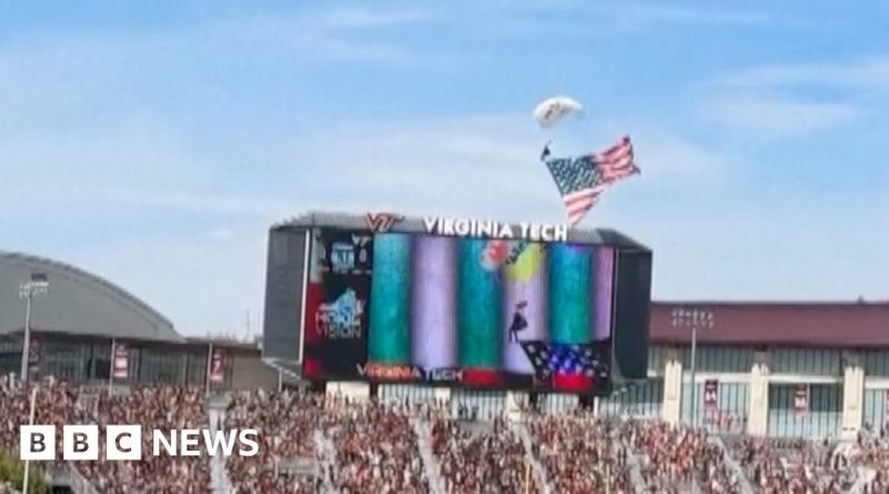 Skydiver incident at football game with responders and jumbotron.