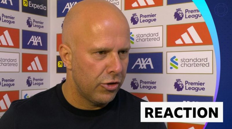 Referee discussing an injury during the Liverpool match, highlighting the focus on player safety.