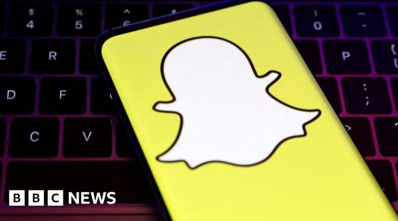 Office scene with employees discussing technology and teamwork, illustrating Snapchat layoffs.