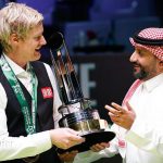 Disappointed snooker players in professional attire at a canceled Saudi Masters event.