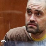 A young man in professional attire reflecting on tragic deaths and family loss.