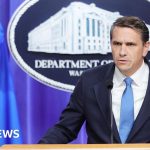 Group of professionals discussing SPLC informant payments in an office.