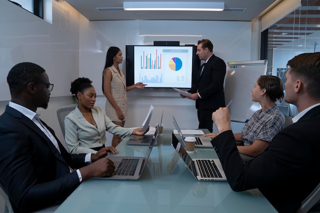 A group of professionals discussing economic challenges during a Starmer conference.