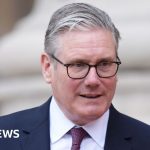 Group of politicians discussing Starmer Robbins comments in formal attire.