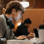 Students celebrating loan repayment relief in a university setting.