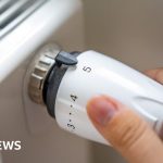 Professionals discussing the heating oil support program in an office.