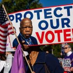 Diverse professionals discussing electoral maps in a bright office setting.