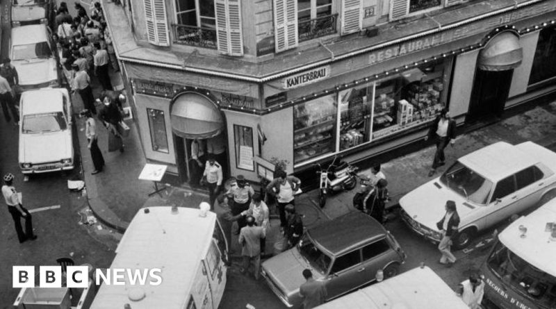 Group of professionals discussing the 1982 Paris restaurant attack case.