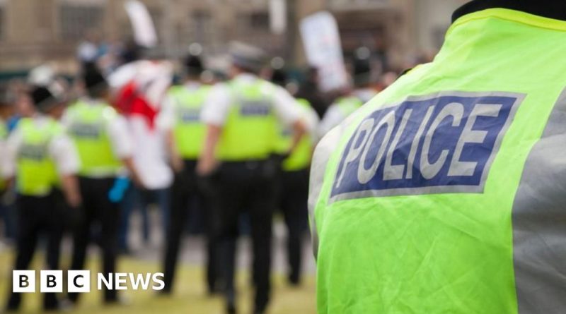 Diverse professionals discussing safety at a media office following a firebomb attack in London.