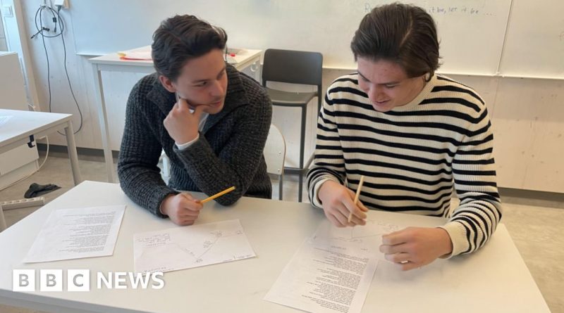 Traditional learning methods in a Swedish classroom with students engaged in their studies.